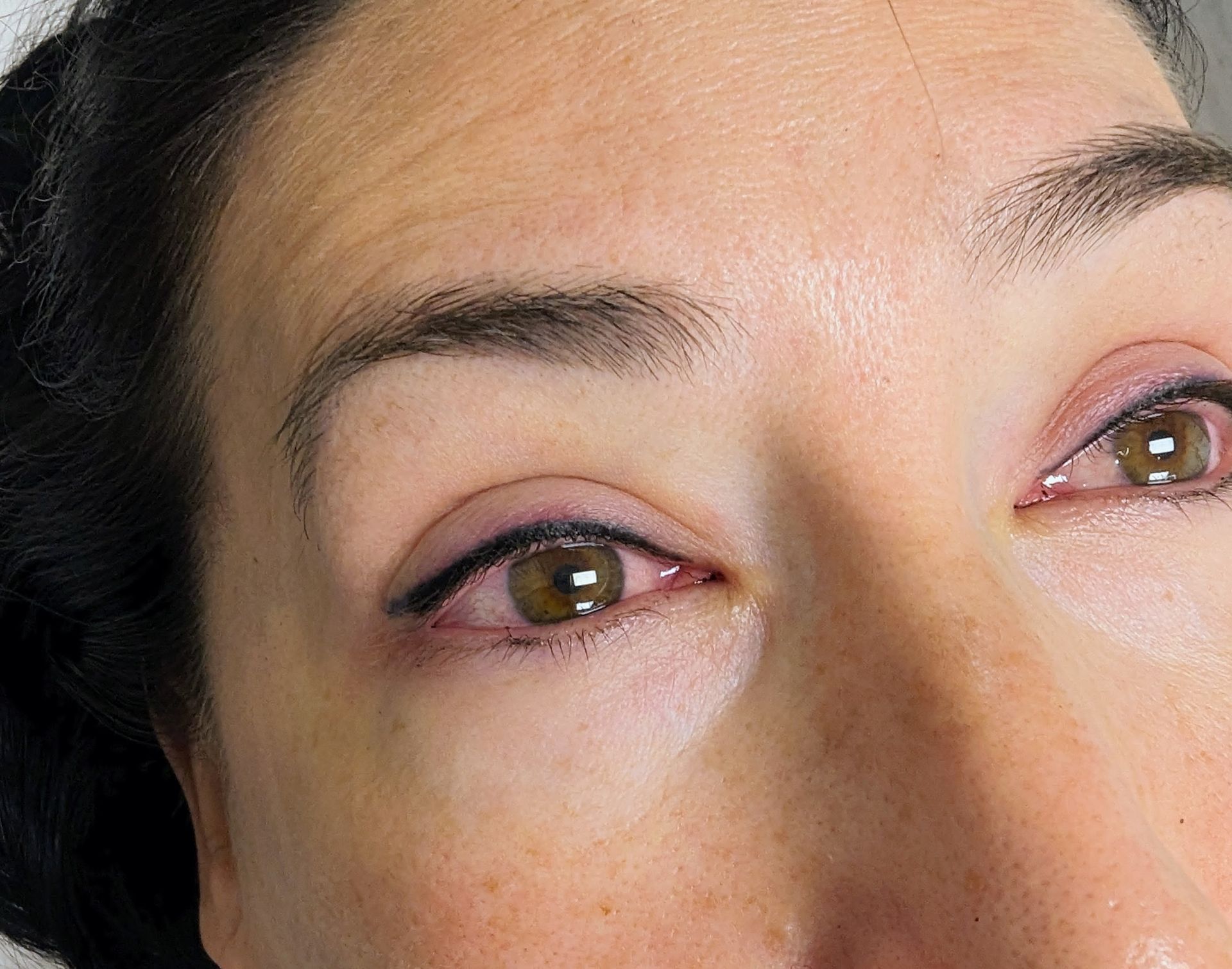 A close up of a woman 's face with her eyes closed.