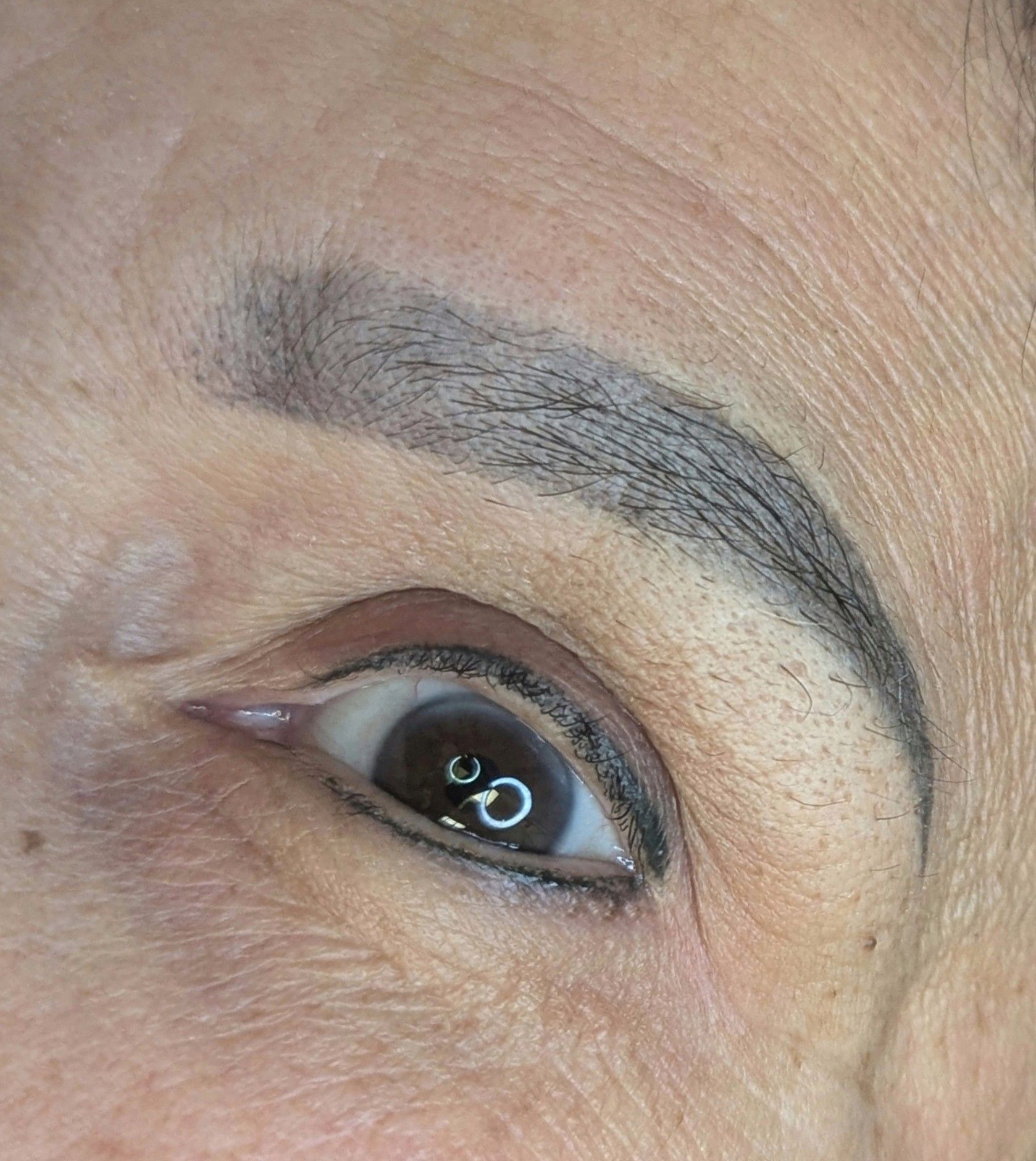 A close up of a woman 's eye with eyeliner on it.