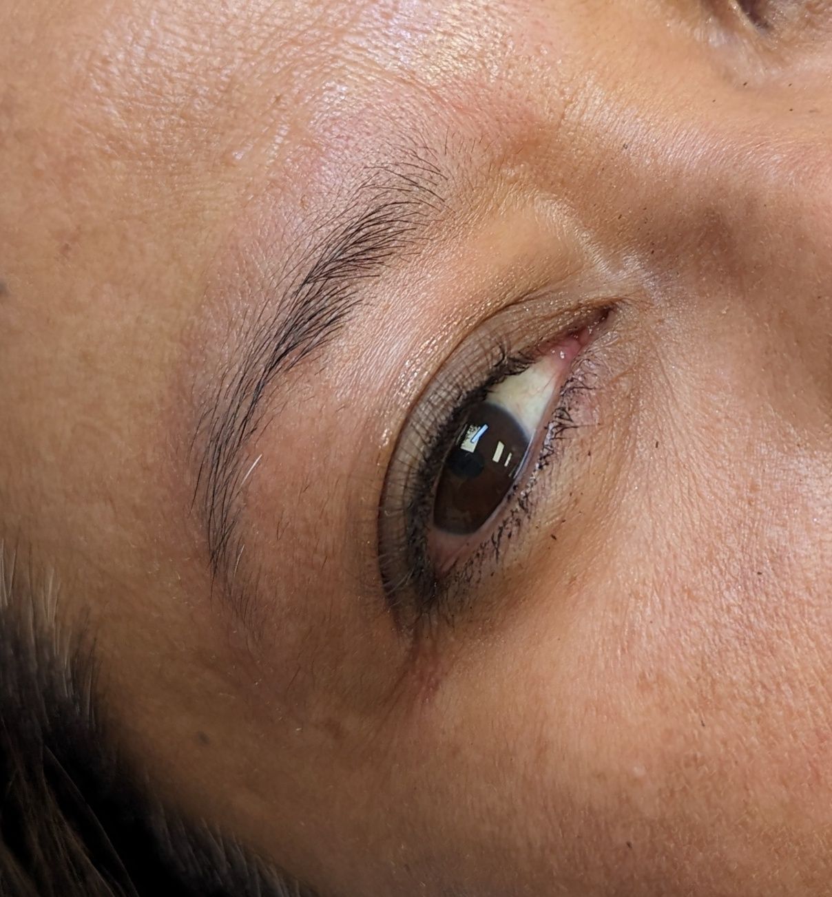 A close up of a woman 's eye and eyebrows.