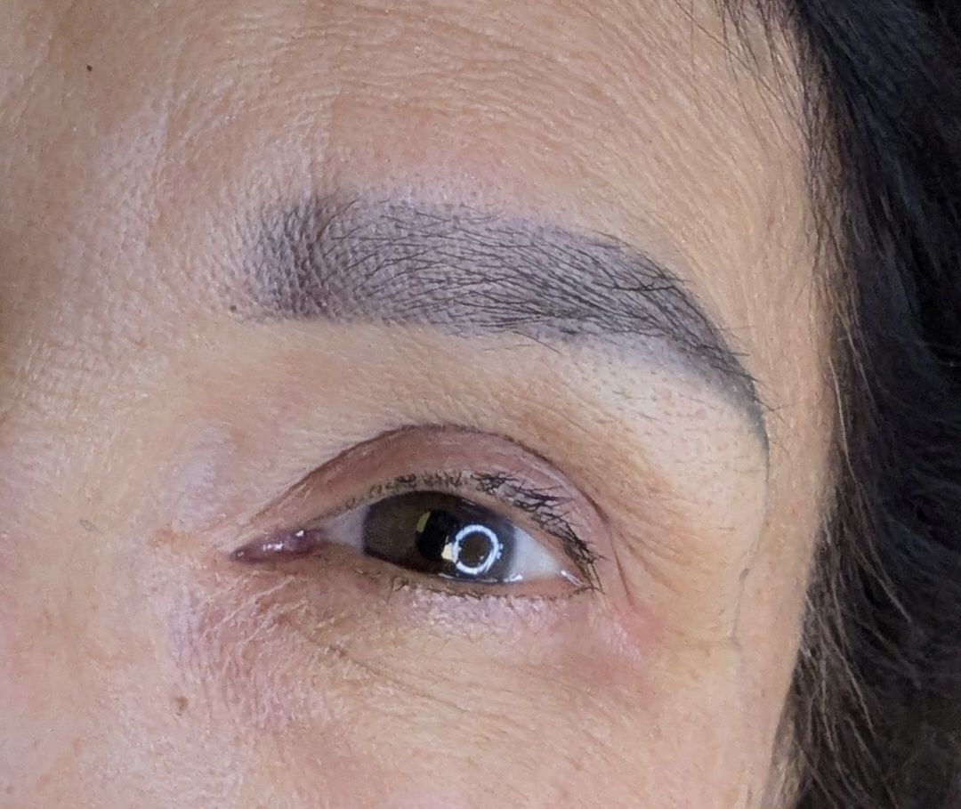 A close up of a woman 's eye and eyebrows.