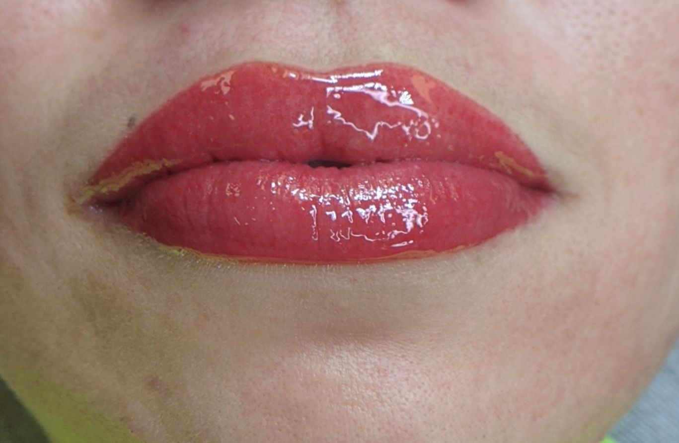 A close up of a woman 's lips with red lipstick.