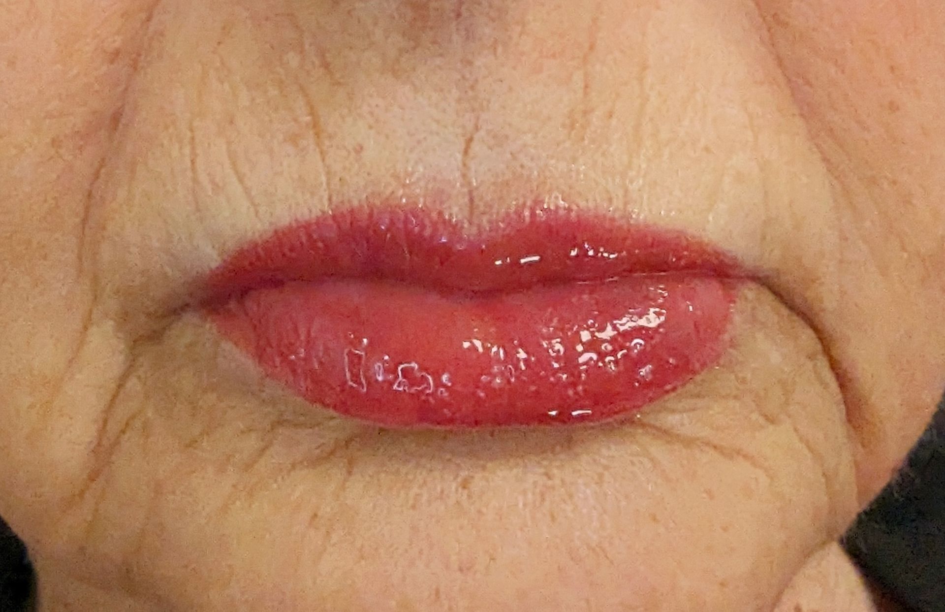 A close up of a woman 's lips with red lipstick.