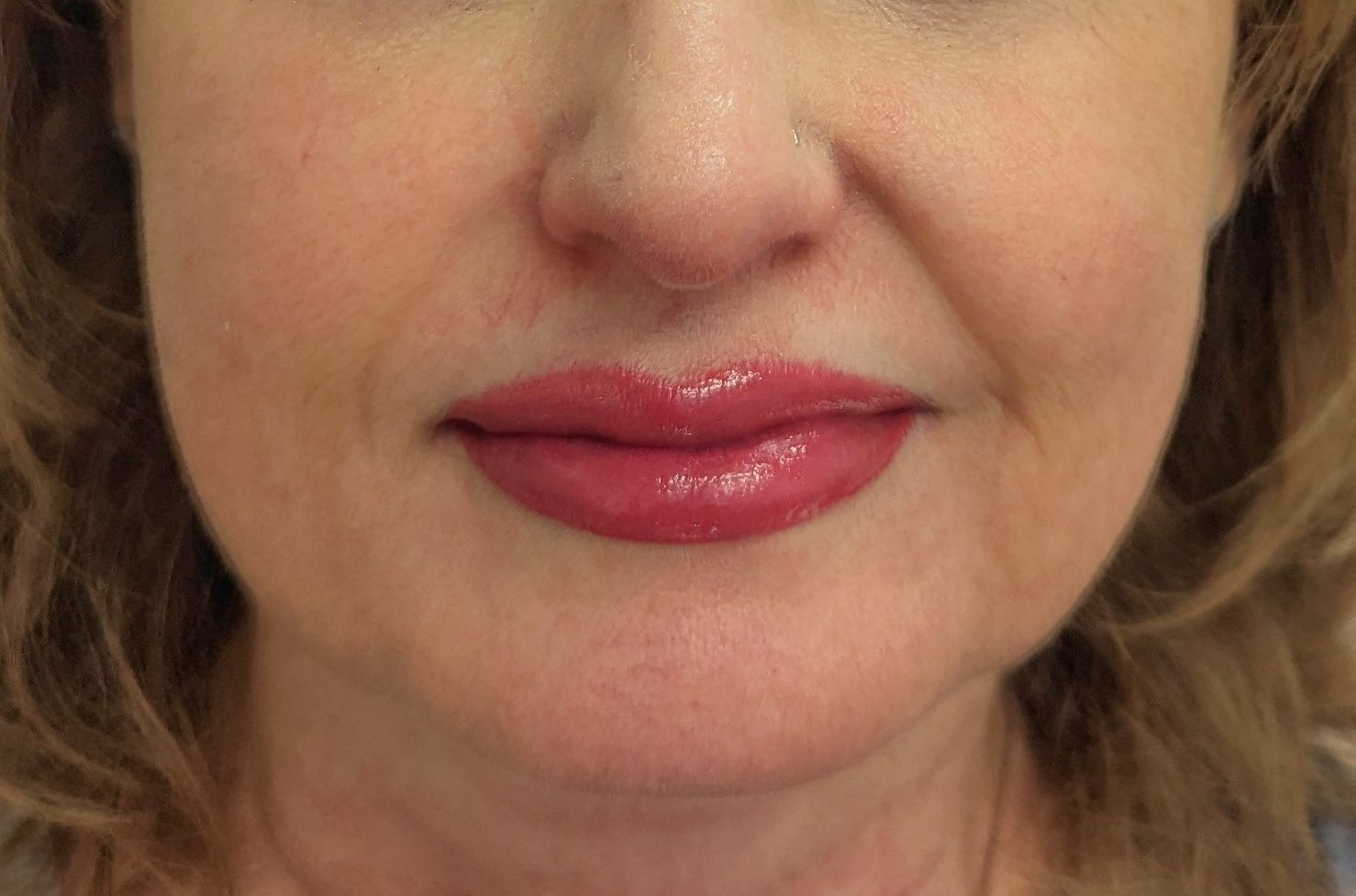 A close up of a woman 's face with red lips.