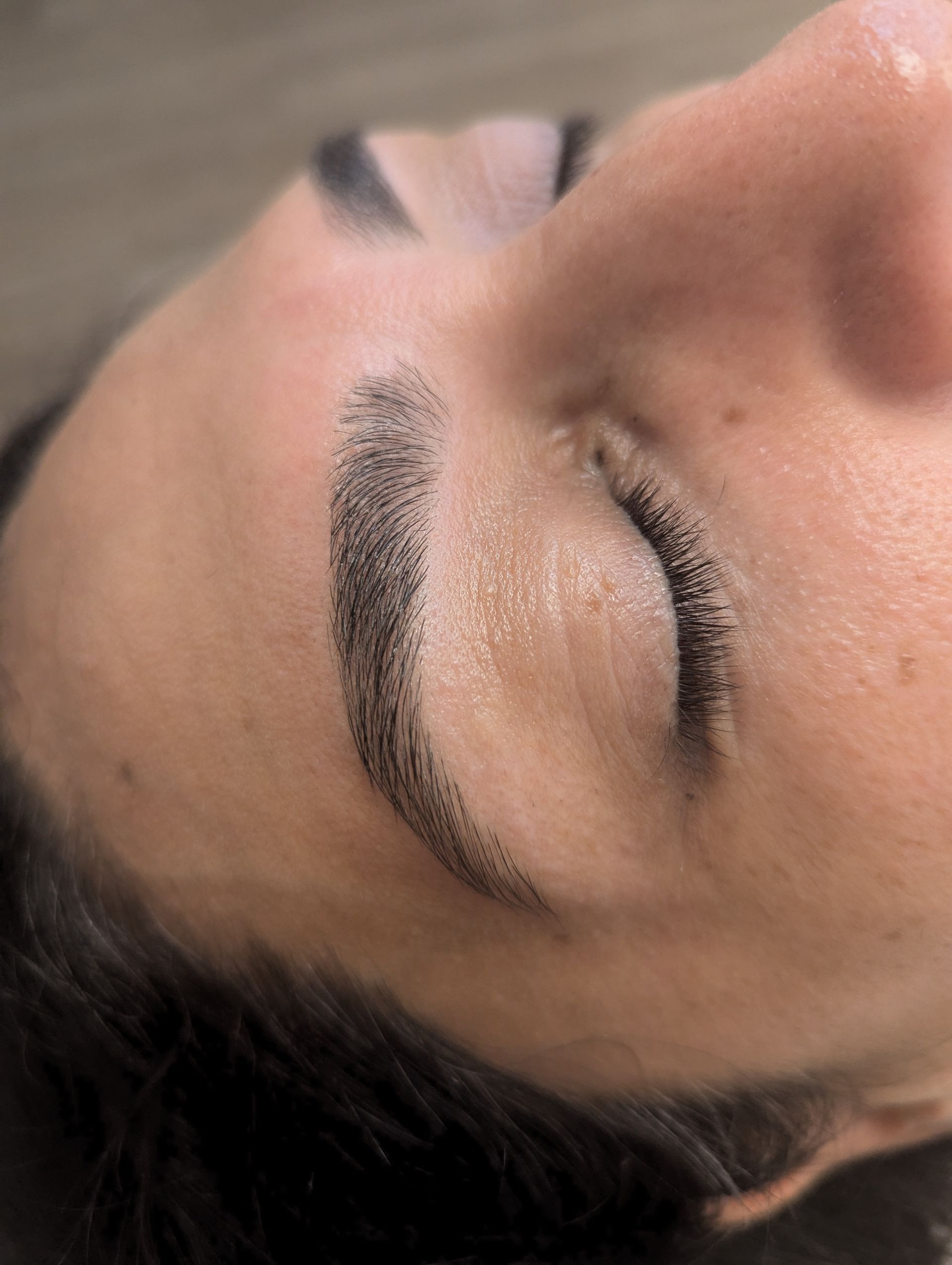 A close up of a woman 's face with her eyes closed.