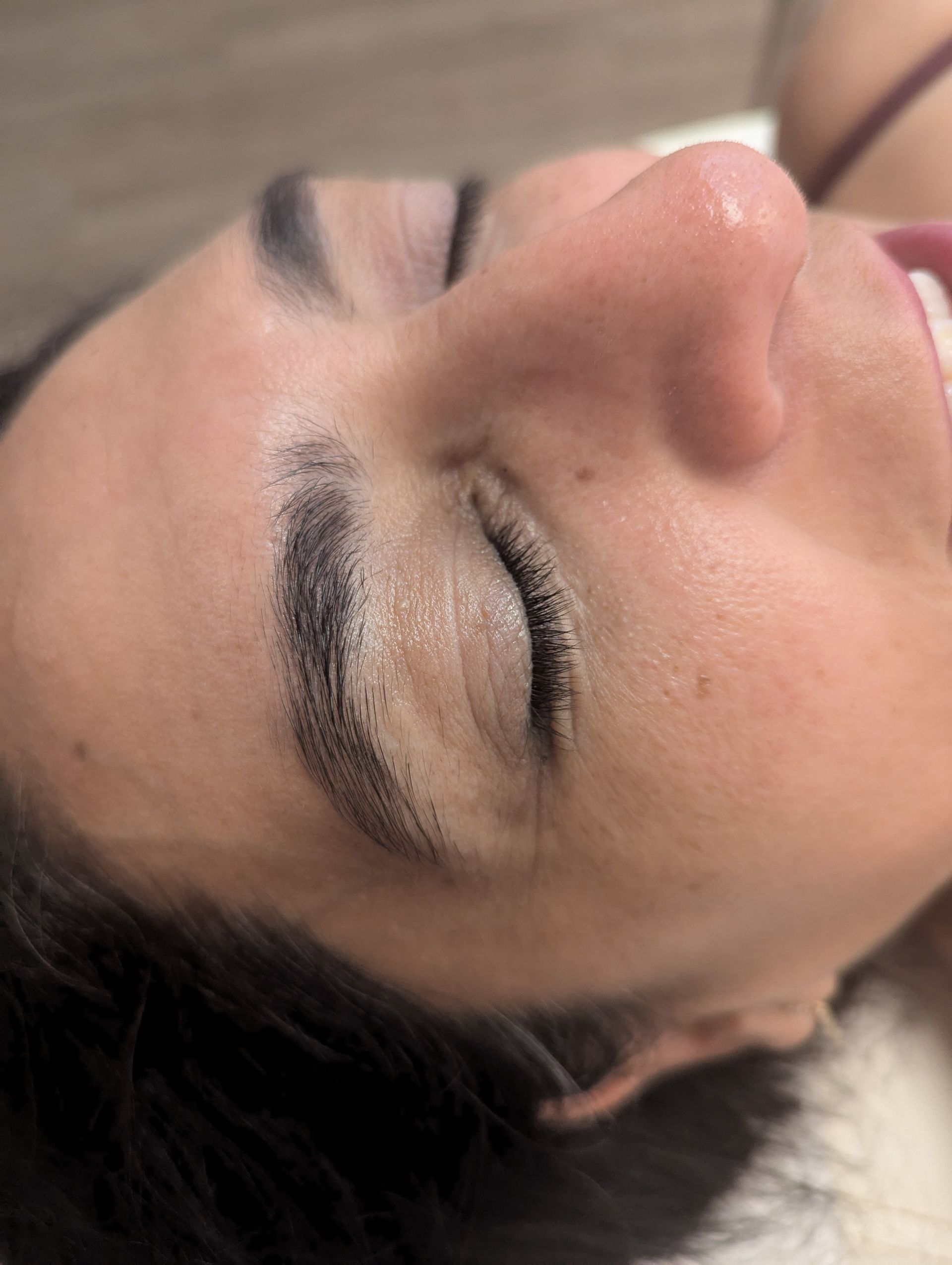 A close up of a woman 's face with her eyes closed.