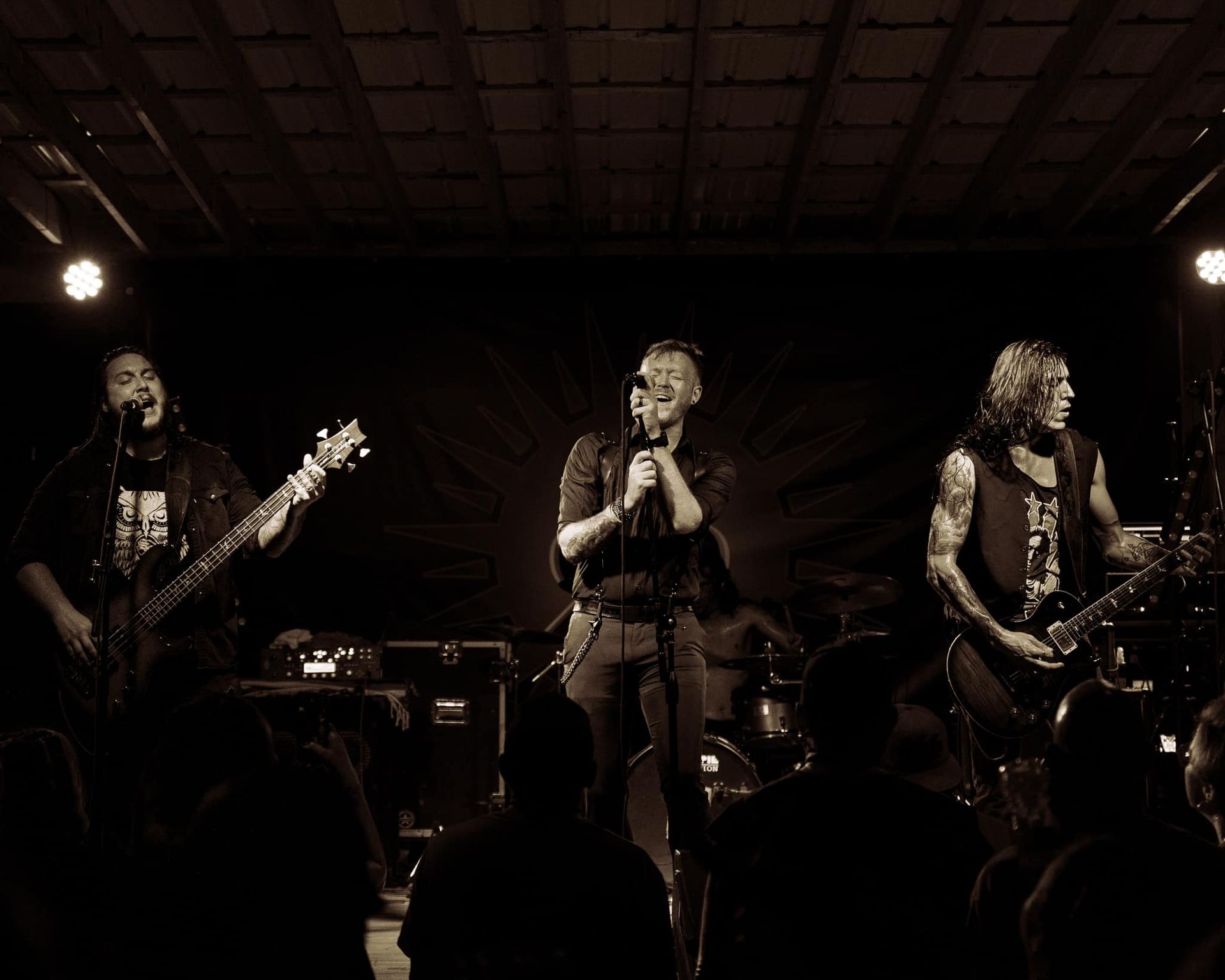 A black and white photo of a band on stage