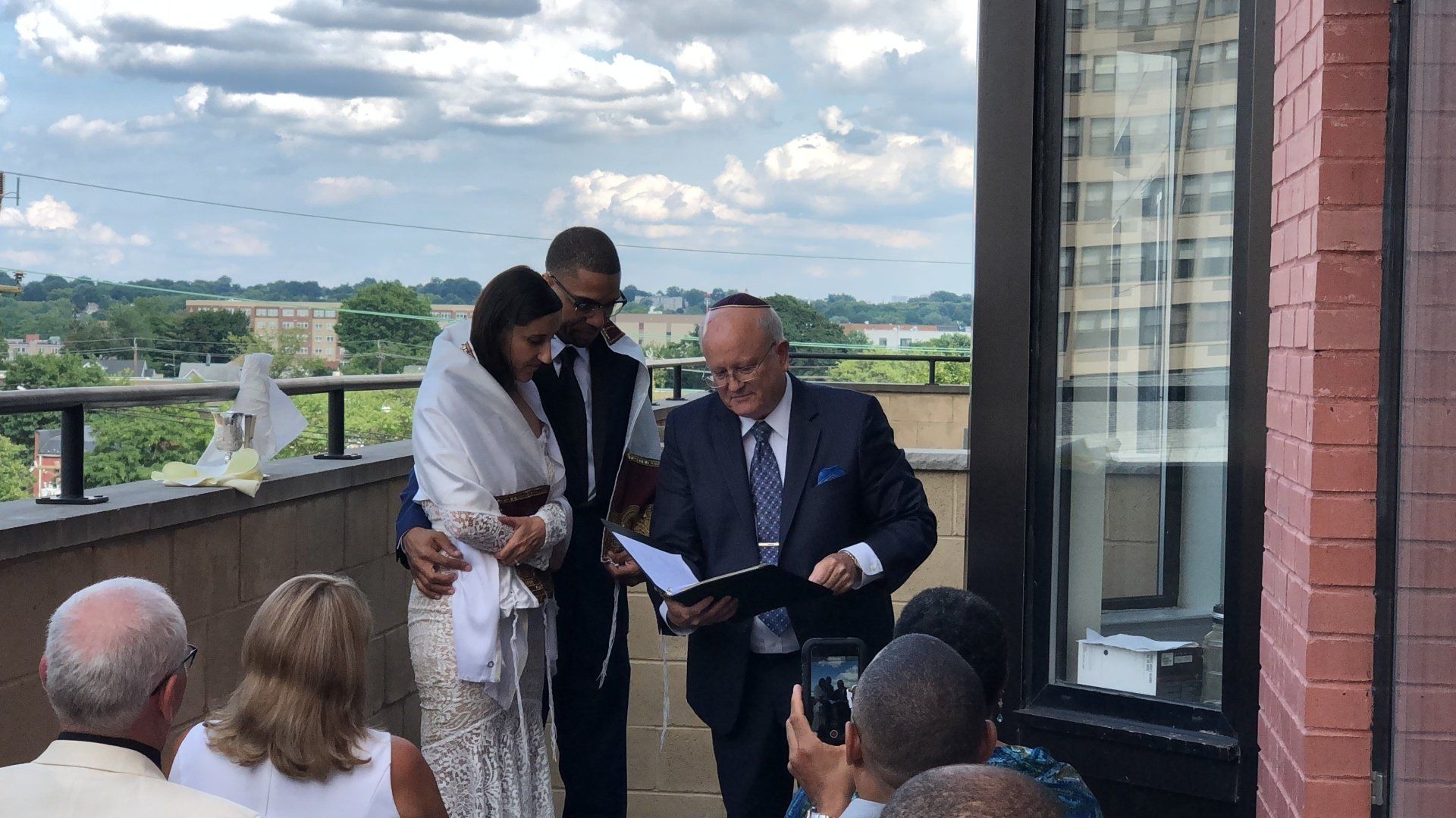 officiating a wedding ceremony on a balcony in Hackensack NJ