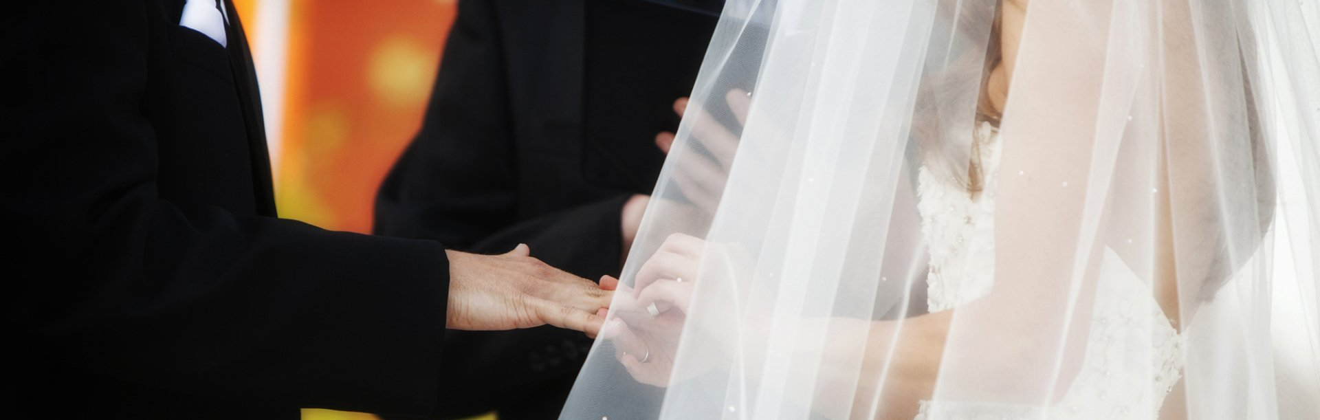 bride giving a ring to the groom