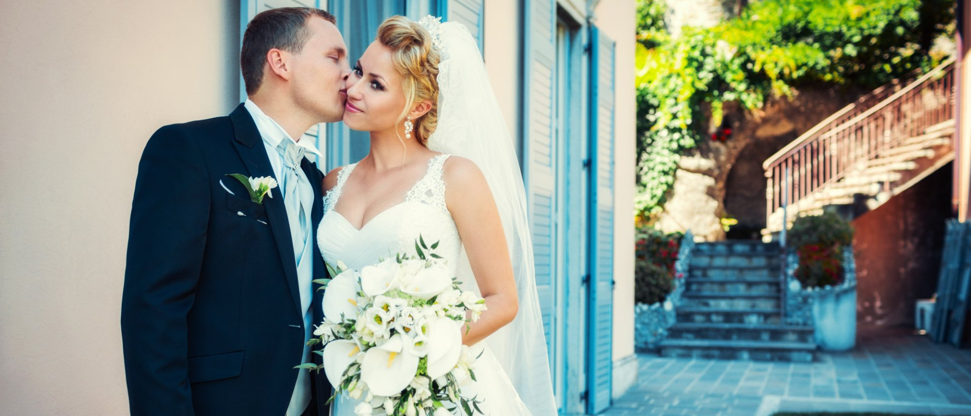 a handsome groom kissing his beautiful wife