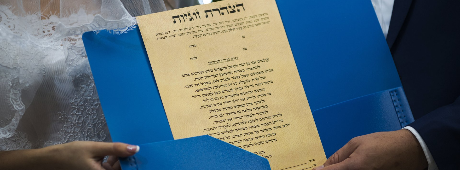 jewish couple holding a marriage contract (ketubah)