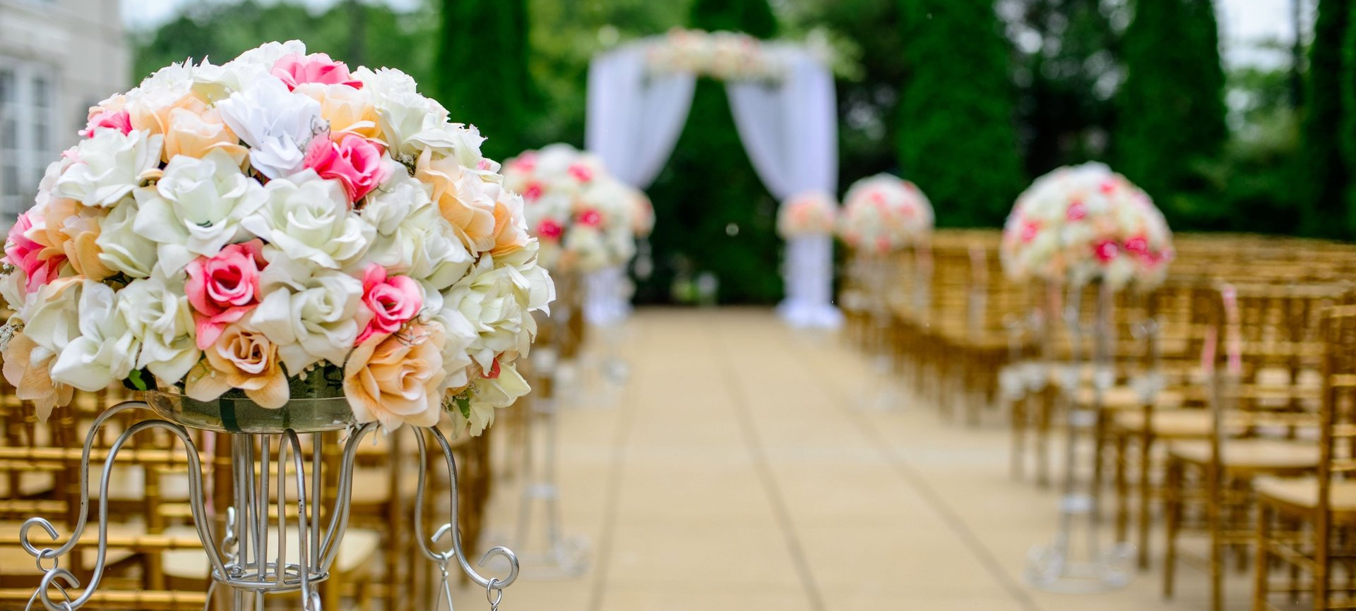 beautiful floral bouquet arrangements along wedding aisle