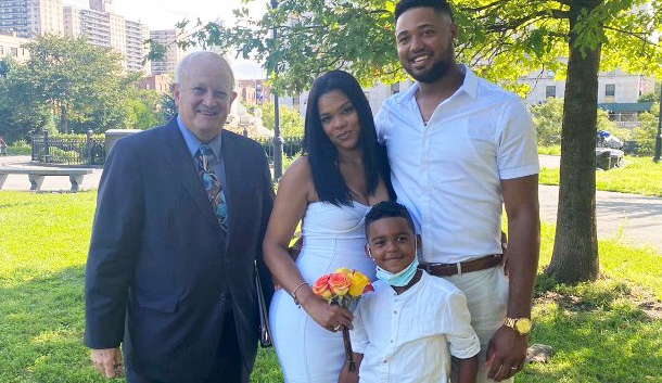 New York wedding in the park with newlyweds, child, and officiant