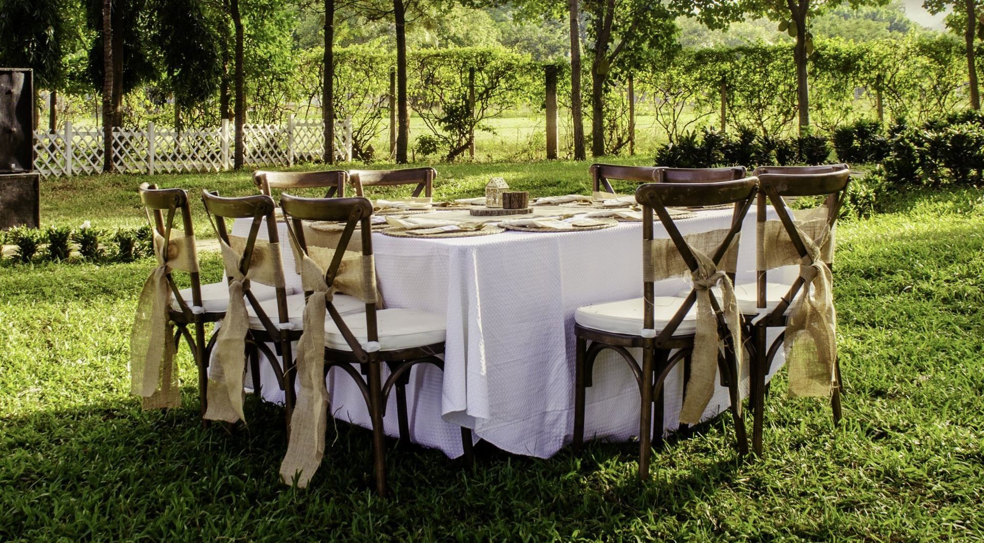 a table in the backyard decorated for a wedding ceremony