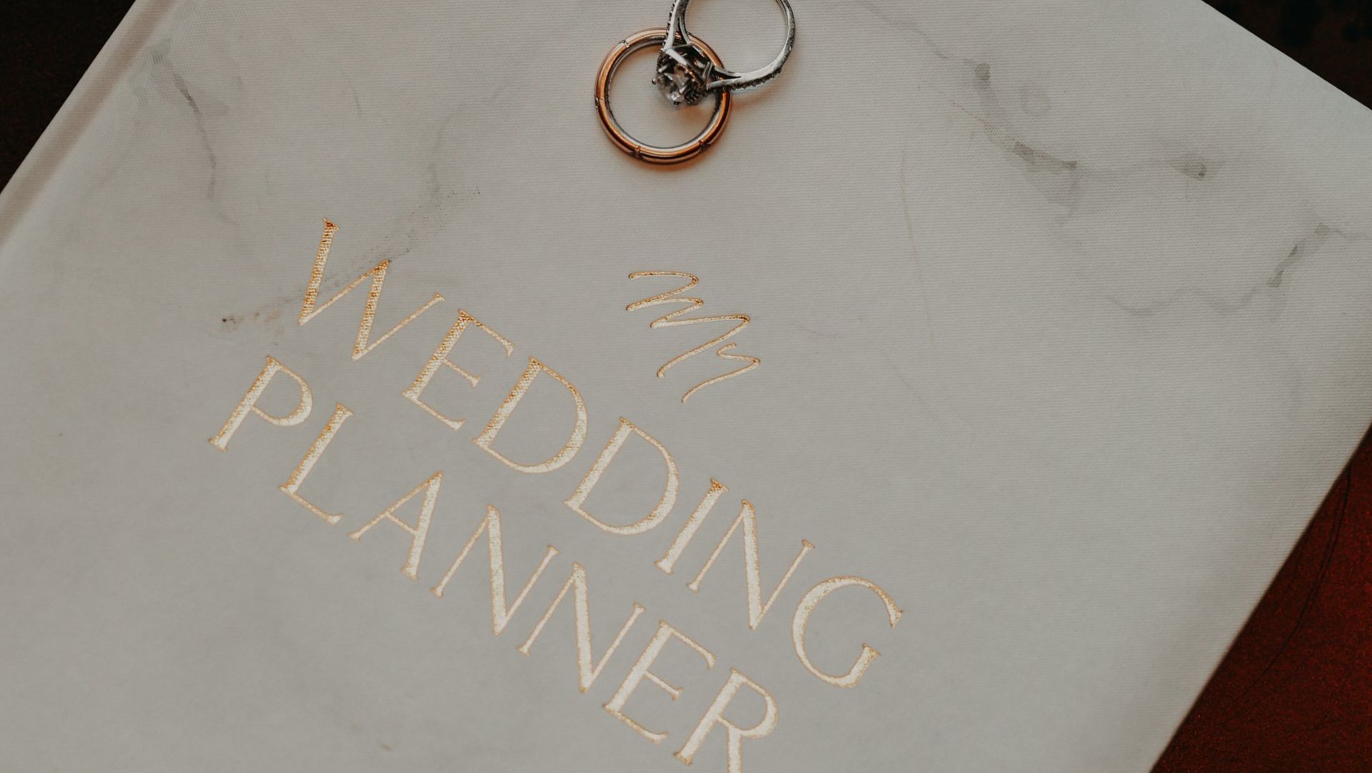 book for wedding planning with two rings on top of it.