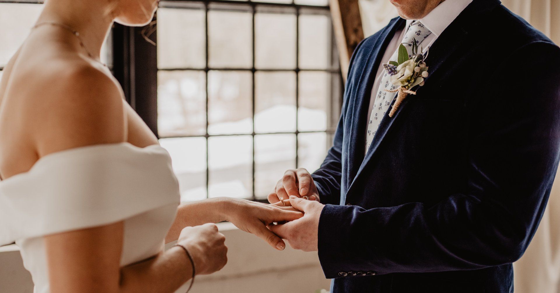 the groom gives wedding ring to bride at wedding ceremony