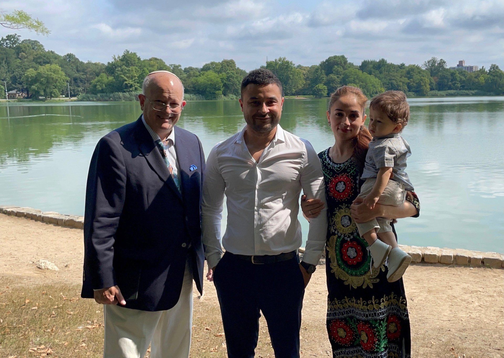 wedding officiant with newly married couple in New York park