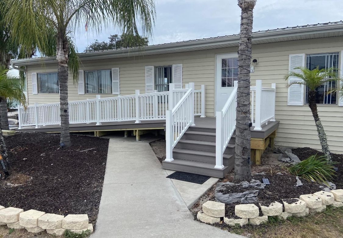 Looking up at a row of tall buildings with palm trees in the foreground.