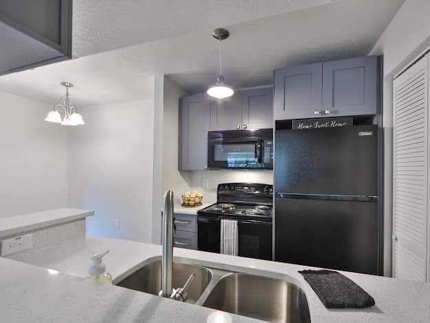 A man is painting a wall in a living room.