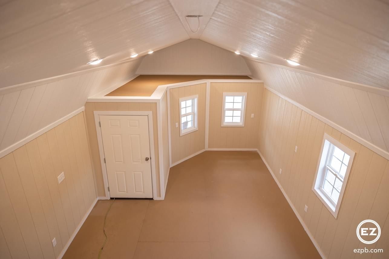 A room with a ceiling that is very high and a lot of windows.