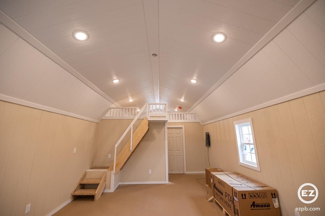 An empty room with a staircase and a box on the floor.