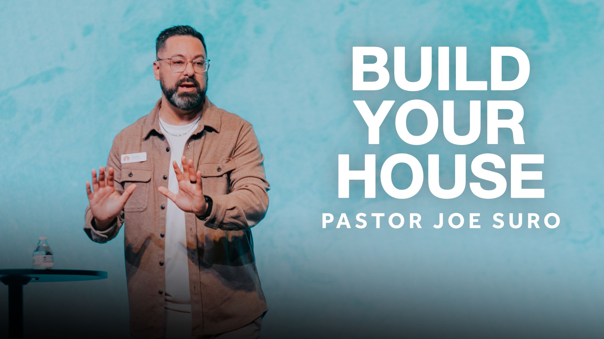 Pastor preaching during the City Church message titled ‘Thankfulness Changes Everything’ with a blue illustrated background.