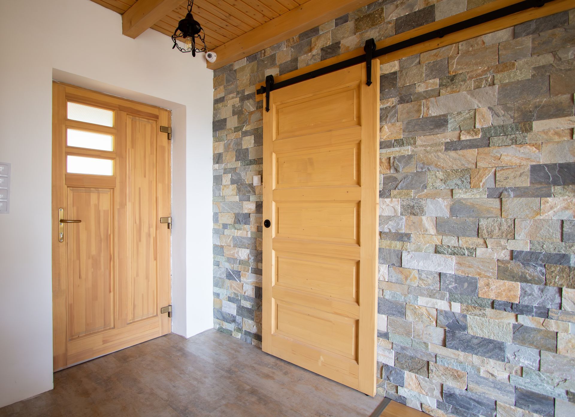 Interior with A Light Wood Sliding Barn Door Beside a Wooden Entry Door — Fineworx Joinery in Warnervale, NSW