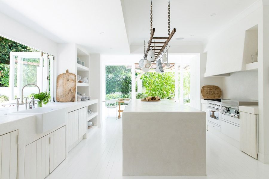 Bright White Modern Kitchen with Open Windows and Hanging Ladder Style Pot Rack — Fineworx Joinery in Warnervale, NSW