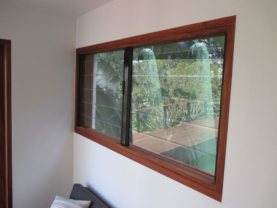 Wood-Framed Window Overlooking a Leafy Outdoor Patio — Fineworx Joinery in Warnervale, NSW