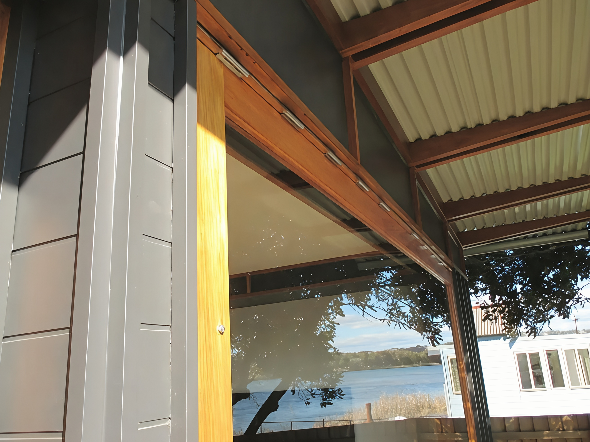 Modern House Porch with Wood Beams and A Large Reflective Window — Fineworx Joinery in Warnervale, NSW