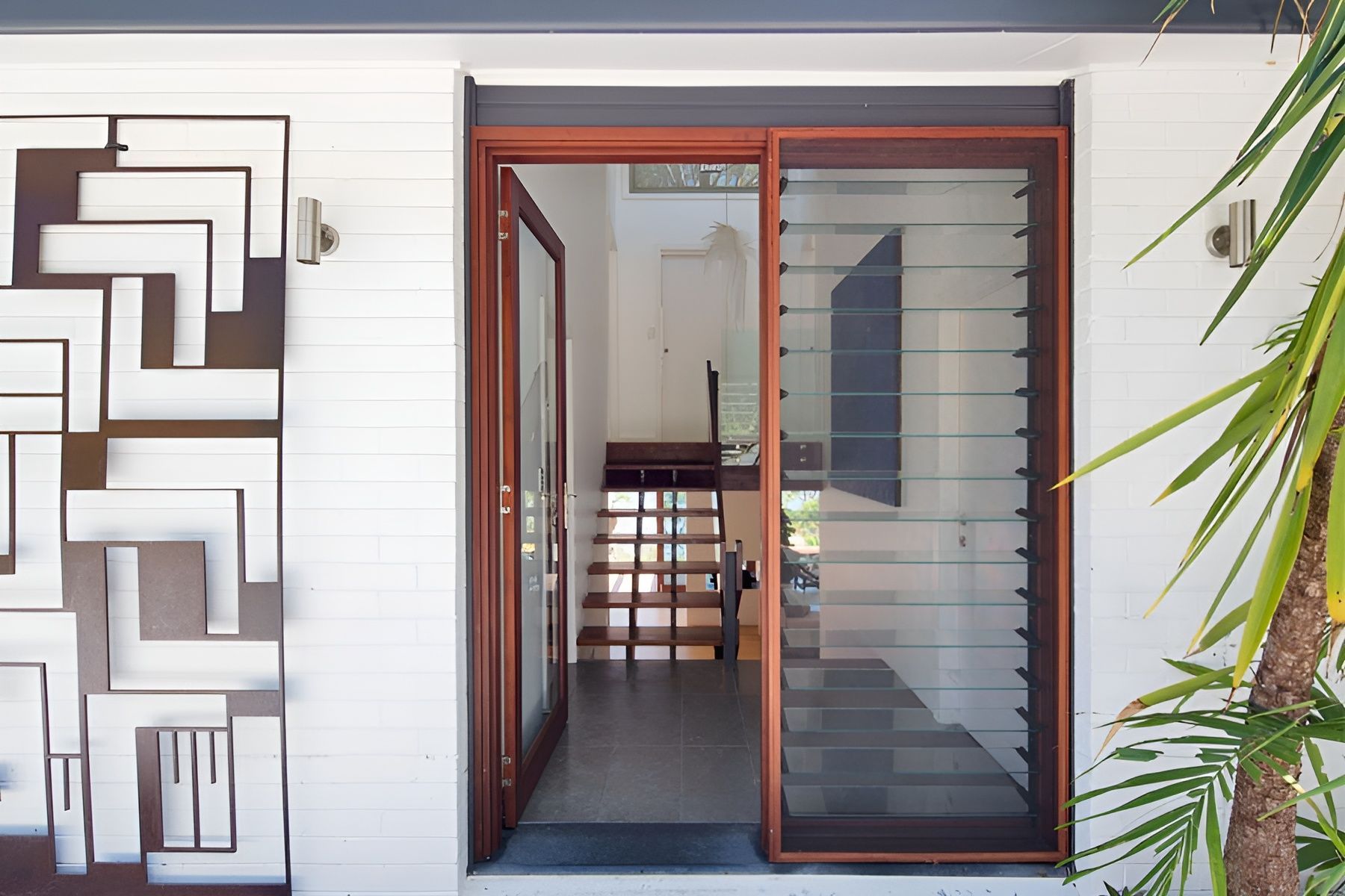 Front Entrance of A Modern Home with A Timber Door  and Decorative Wall Art — Fineworx Joinery in Sydney, NSW