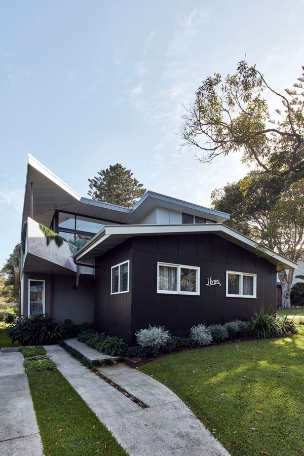 Modern Dark Brown House with A Curved Roof and Green Lawn Under Trees — Fineworx Joinery in Newcastle, NSW