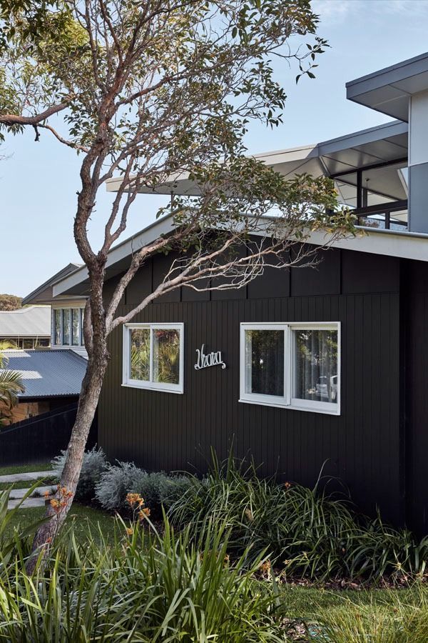 Black House Exterior with White Trimmed Windows — Fineworx Joinery in Warnervale, NSW