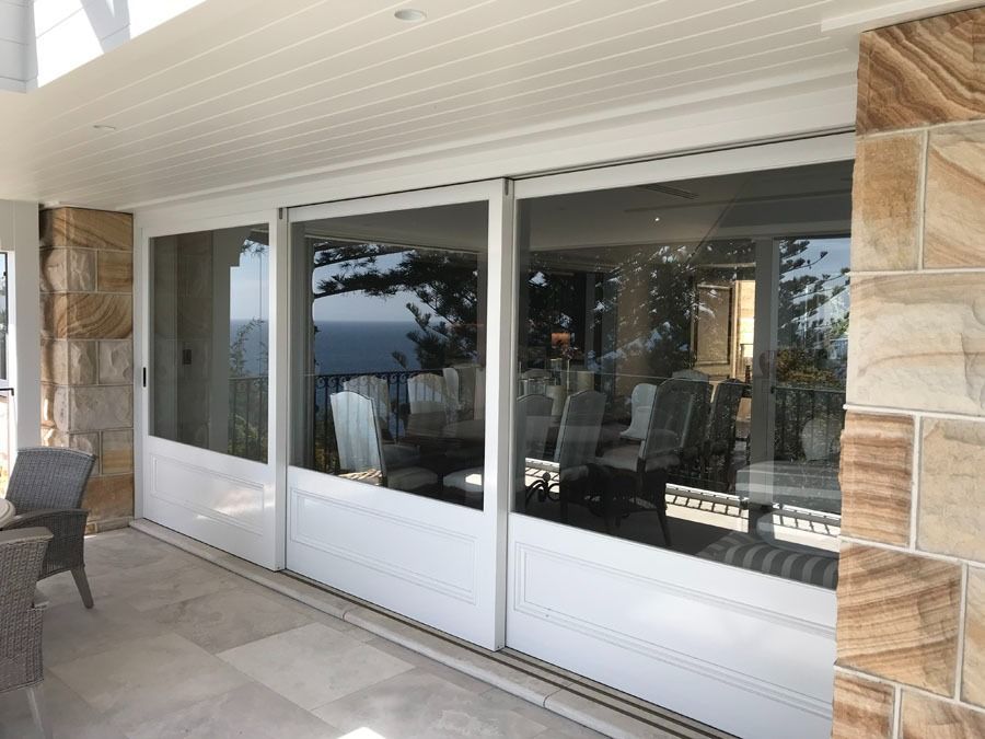 Patio Sliding Glass Doors Reflecting Trees — Fineworx Joinery in Warnervale, NSW