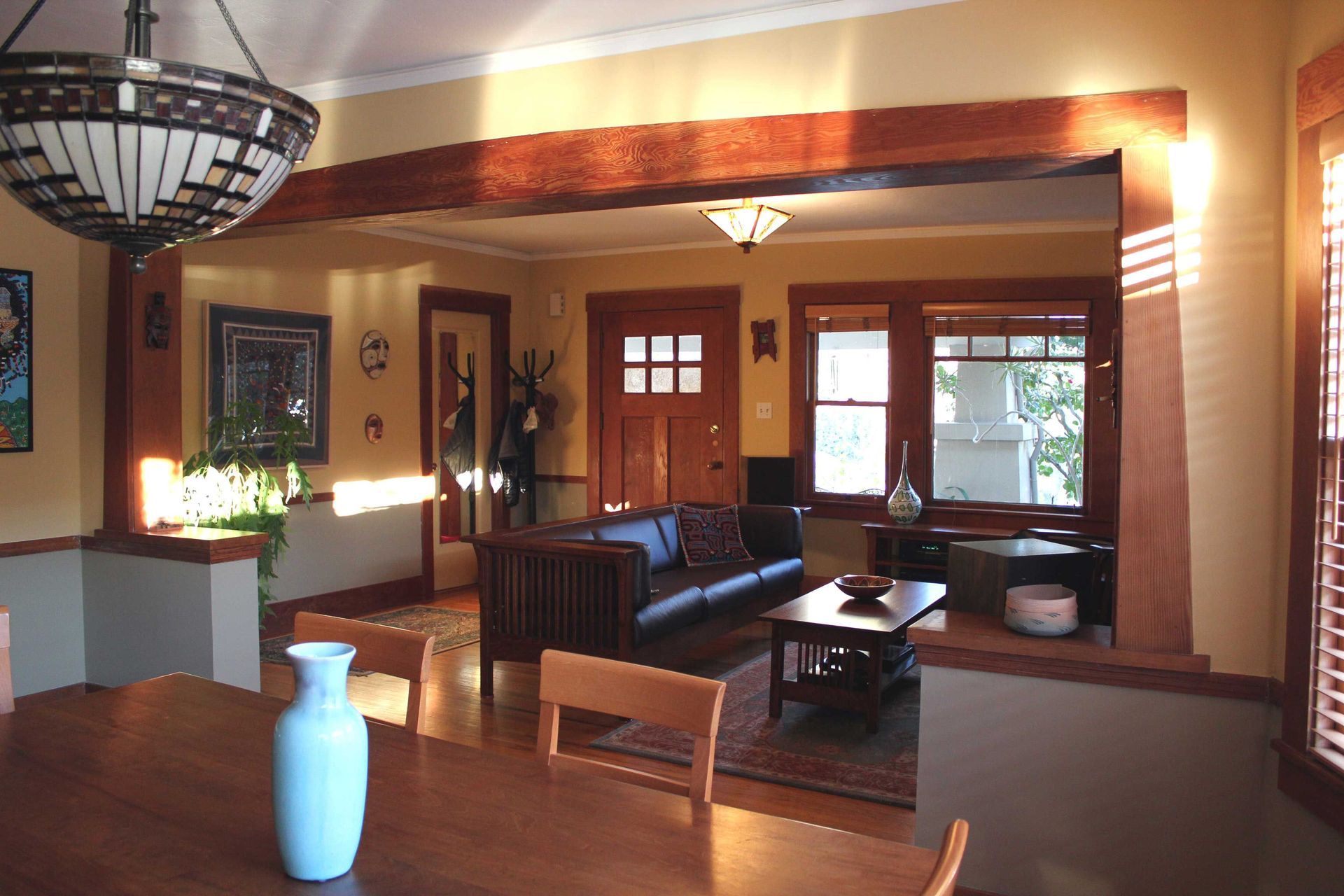 Interior house. Dining room and living room. Lots of wood and stained glass.