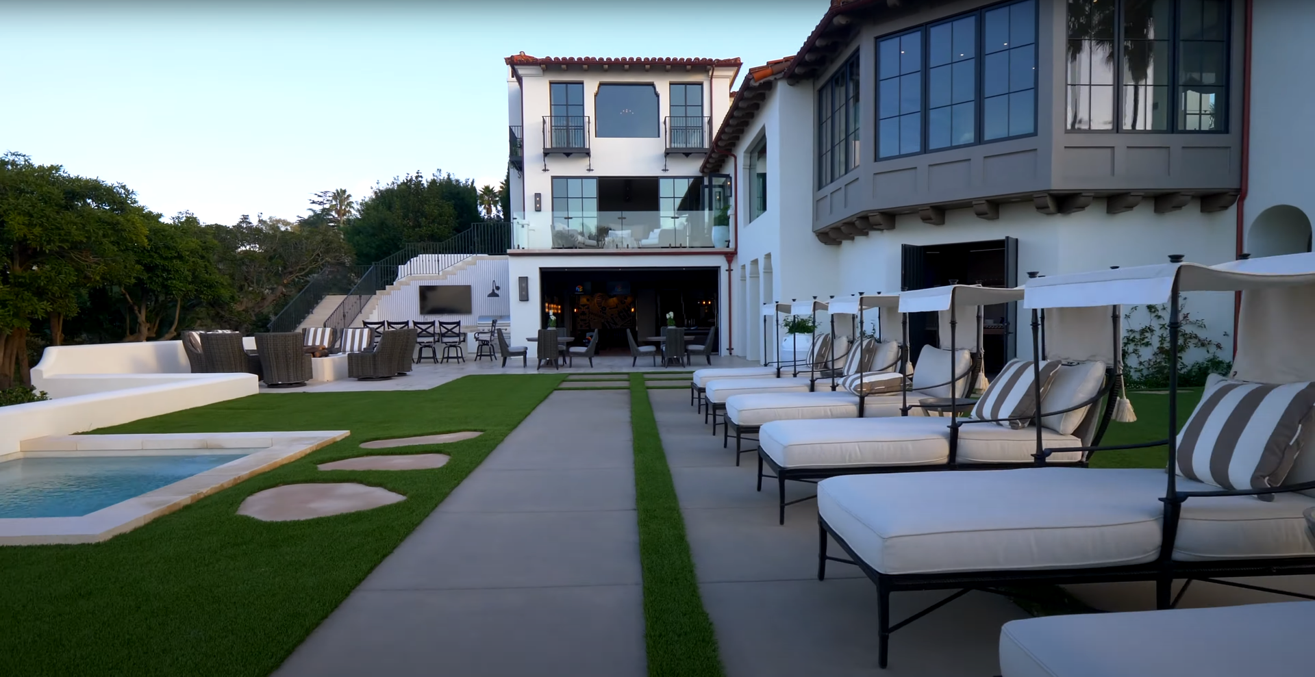 A large white house with a swimming pool in the backyard