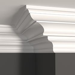 Close up of crown moulding and a dark grey wall
