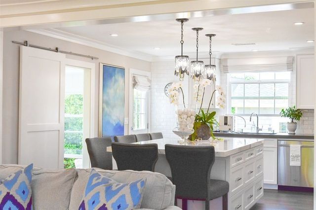 A living room with a couch , chairs , and a large island in the middle of the room.
