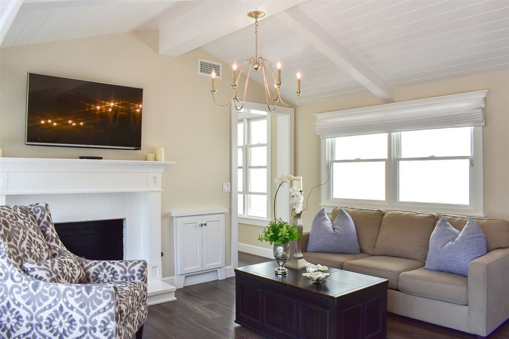 A living room with a couch a chair and a flat screen tv