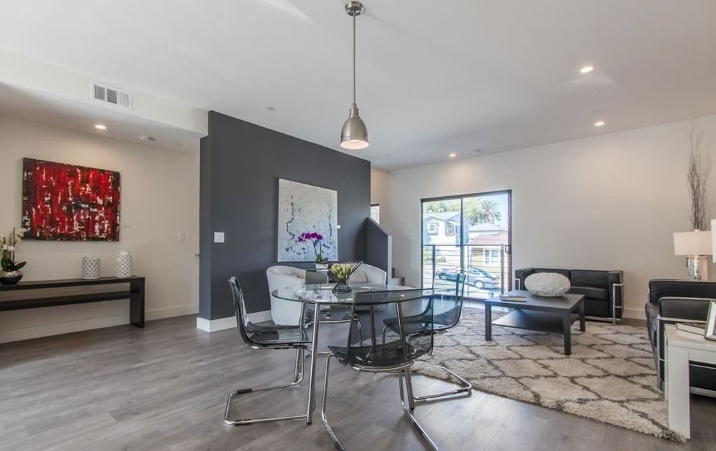 A living room with a dining table and chairs