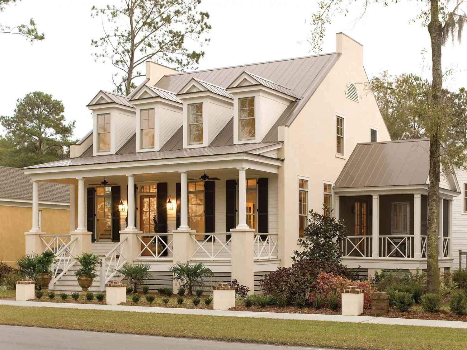 A white house with a large front porch.
