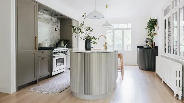 A kitchen with a large island in the middle of the room.