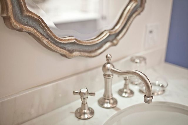 A bathroom sink with a mirror above it and a faucet