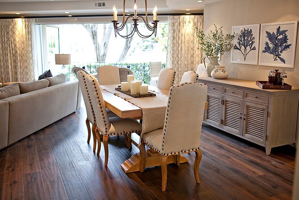 A dining room with a table and chairs and a chandelier