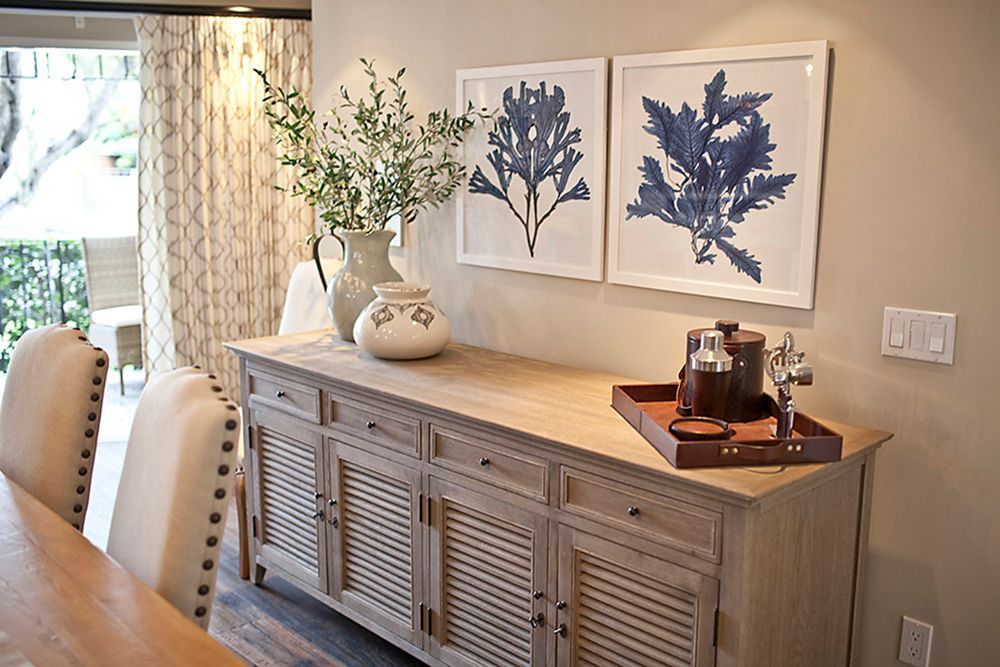 A dining room with a buffet table and chairs