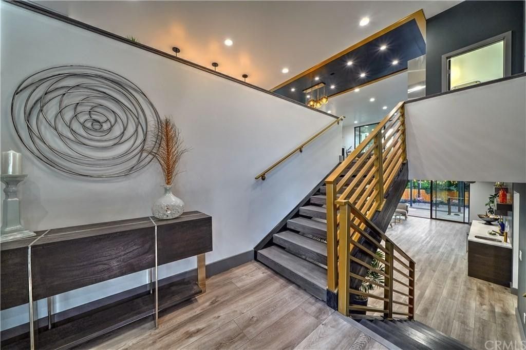 A hallway with stairs leading up to the second floor of a house.