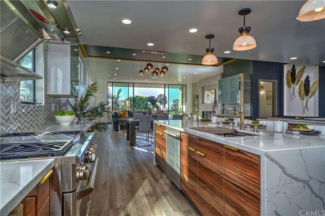 A kitchen with stainless steel appliances and wooden cabinets