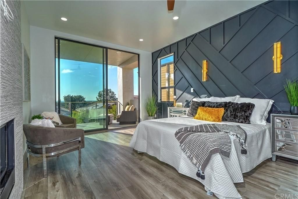 A bedroom with a large bed and sliding glass doors