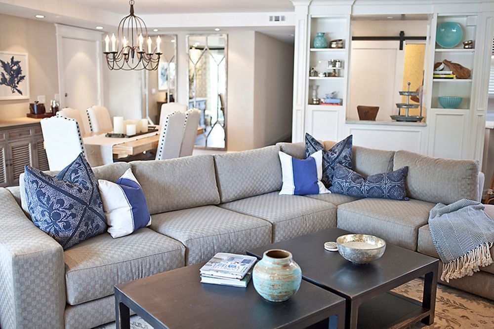 A living room with a sectional couch and a coffee table