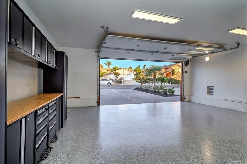 An empty garage with a large garage door open