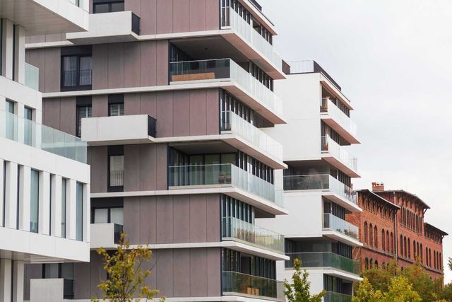A row of apartment buildings with balconies in a city.